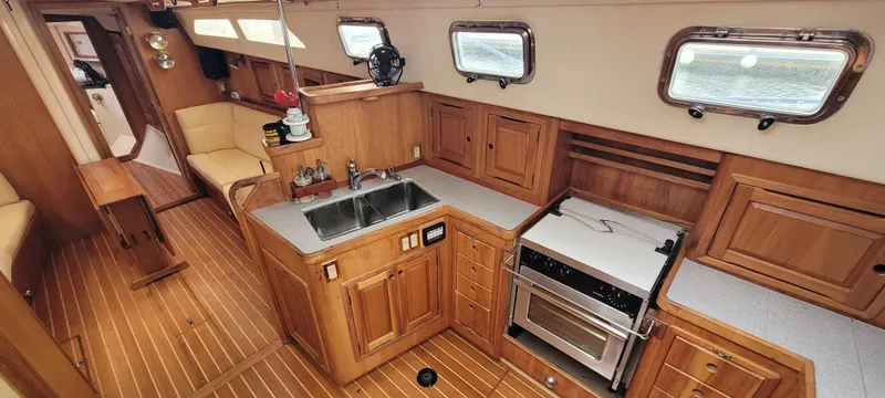 Slide: The Image of Interior of 1997 Saga 43 yacht with wooden cabinetry and modern kitchen amenities. - 2