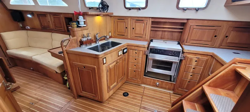 Slide: The Image of Luxurious 1997 Saga 43 yacht interior with wooden cabinetry and modern kitchen amenities. - 20
