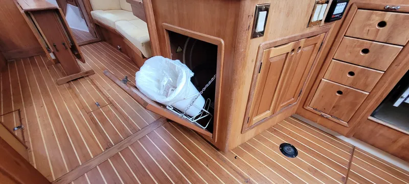 Slide: The Image of Wooden interior of 1997 Saga 43 boat with storage compartments and seating area. - 22