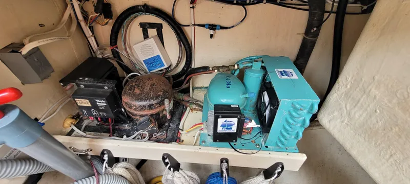 Slide: The Image of Engine room of a 1997 Saga 43 boat, featuring mechanical and electrical components. - 23