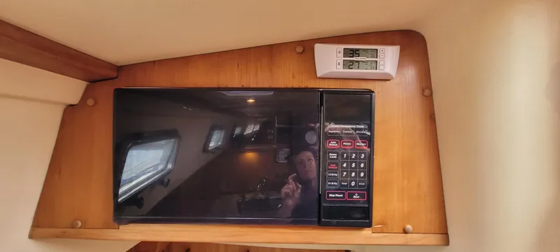 Slide: The Image of Microwave in 1997 Saga 43 boat interior with digital thermometer above. - 27