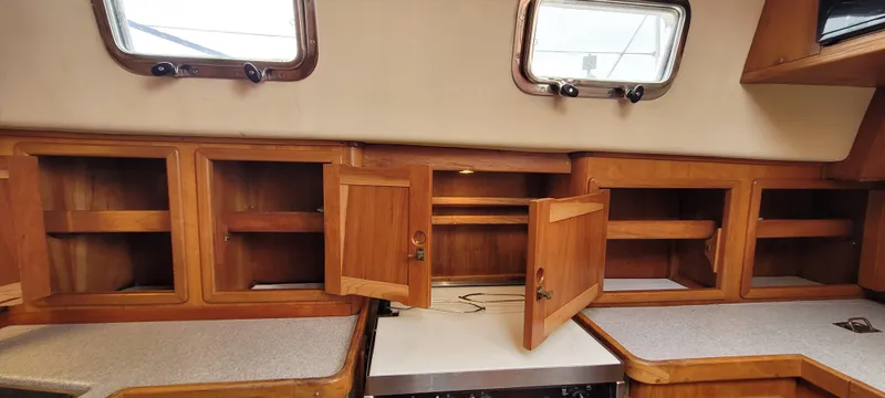 Slide: The Image of Interior of 1997 Saga 43 sailboat with wooden cabinets and countertops. - 30