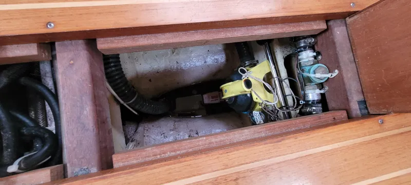Slide: The Image of Wooden floor compartment of a 1997 Saga 43 boat, revealing mechanical components. - 33