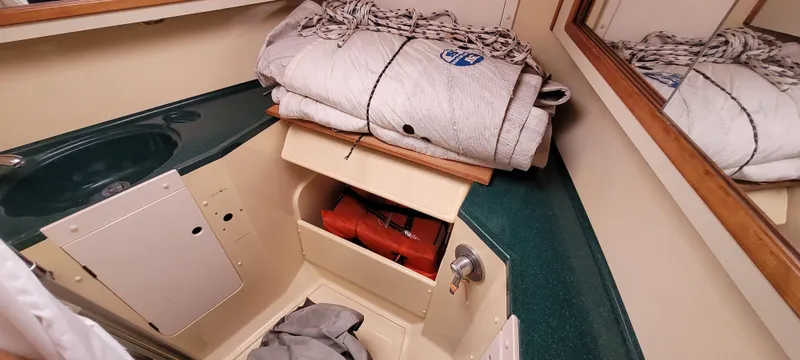 Slide: The Image of Interior of 1997 Saga 43 sailboat with storage and folded sails. - 36