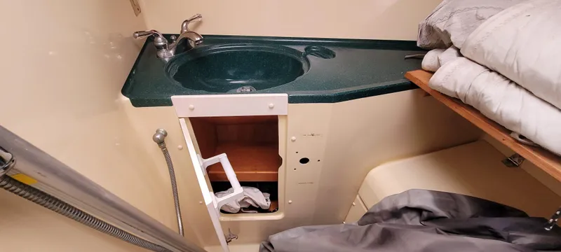 Slide: The Image of Compact bathroom in 1997 Saga 43 boat with green sink and storage. - 37