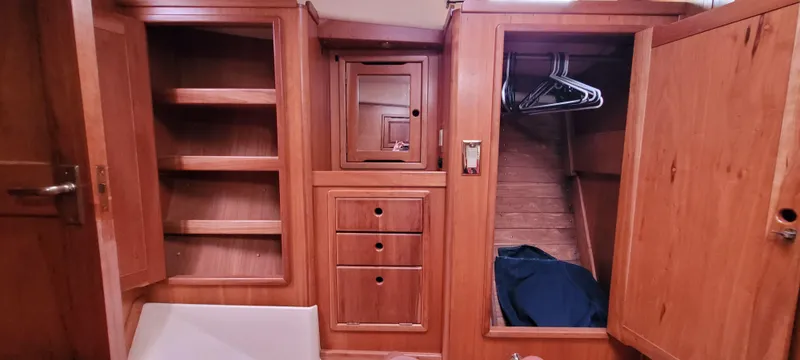 Slide: The Image of Wooden interior storage cabinets and closet in a 1997 Saga 43 boat. - 38