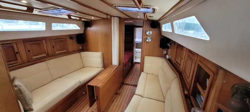 Slide: The Image of Interior of 1997 Saga 43 yacht with wooden finish and beige seating. - 4