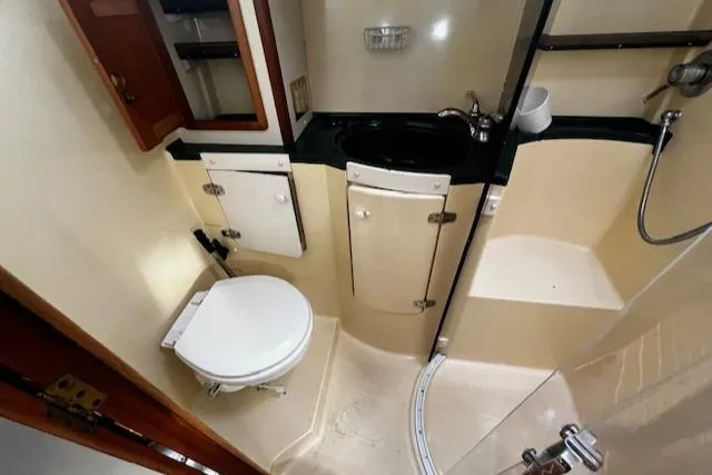 Slide: The Image of Compact bathroom in 1997 Saga 43 boat with toilet, sink, and shower. - 43