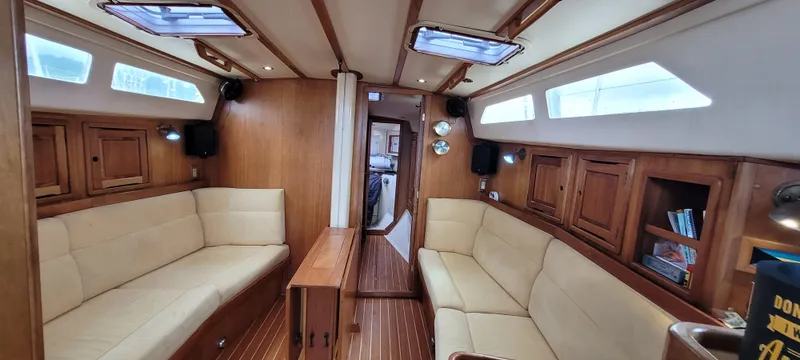 Slide: The Image of Interior of 1997 Saga 43 sailboat with wooden finish and beige seating. - 47