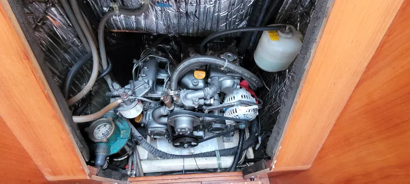 Slide: The Image of Engine compartment of a 1997 Saga 43 boat, showing detailed mechanical components. - 48