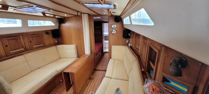Slide: The Image of Interior of 1997 Saga 43 sailboat with wooden finish and beige seating. - 5