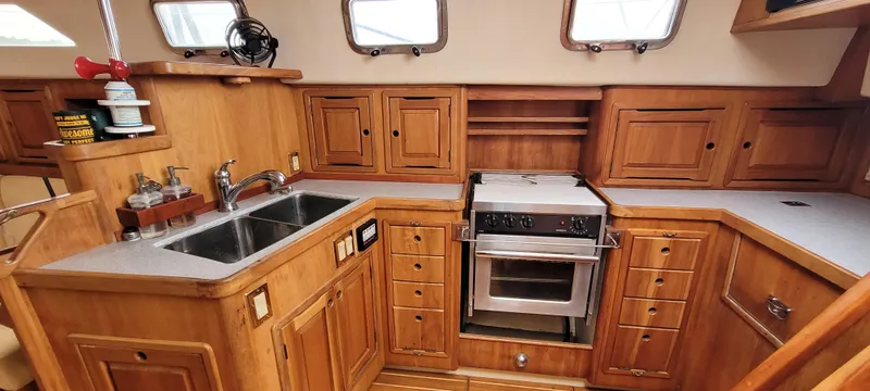 Slide: The Image of Wooden yacht kitchen with double sink, stove, and ample storage. Saga 43, 1997 model. - 8