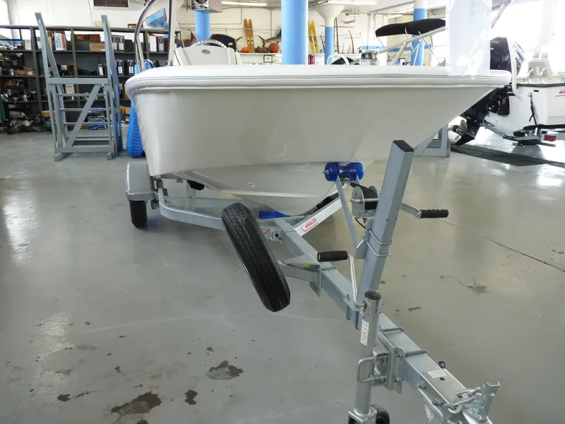 Slide: The Image of 2024 Boston Whaler 130 Super Sport boat on trailer in showroom. - 3