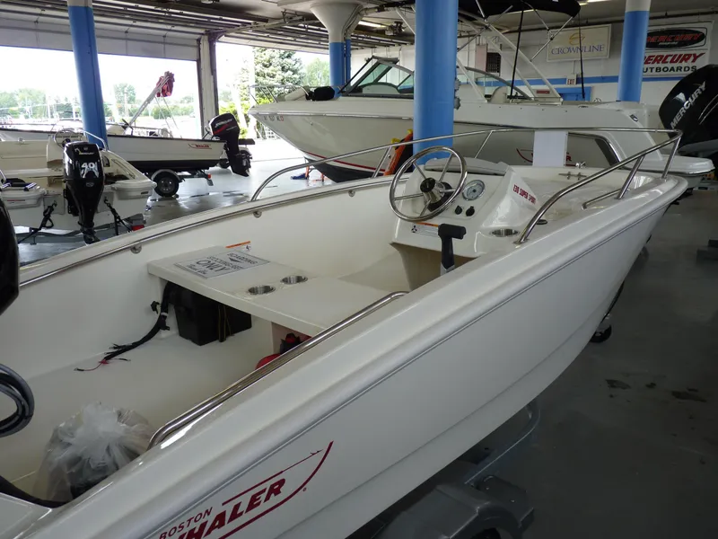Slide: The Image of 2024 Boston Whaler 130 Super Sport boat displayed in showroom. - 4