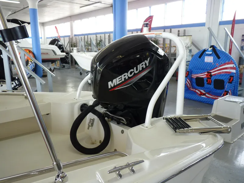 Slide: The Image of 2024 Boston Whaler 160 Super Sport with Mercury outboard motor in showroom. - 5
