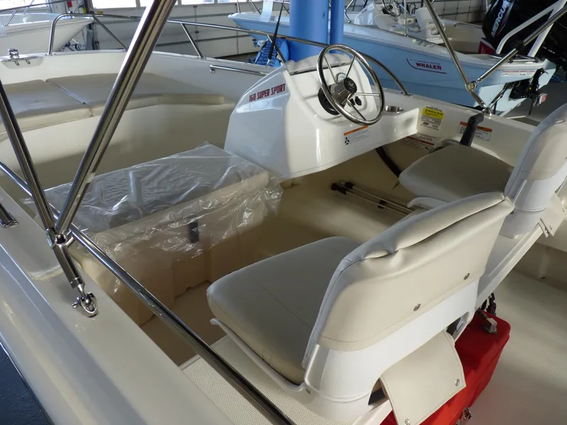 Slide: The Image of 2024 Boston Whaler 160 Super Sport interior with steering wheel and seating. - 7