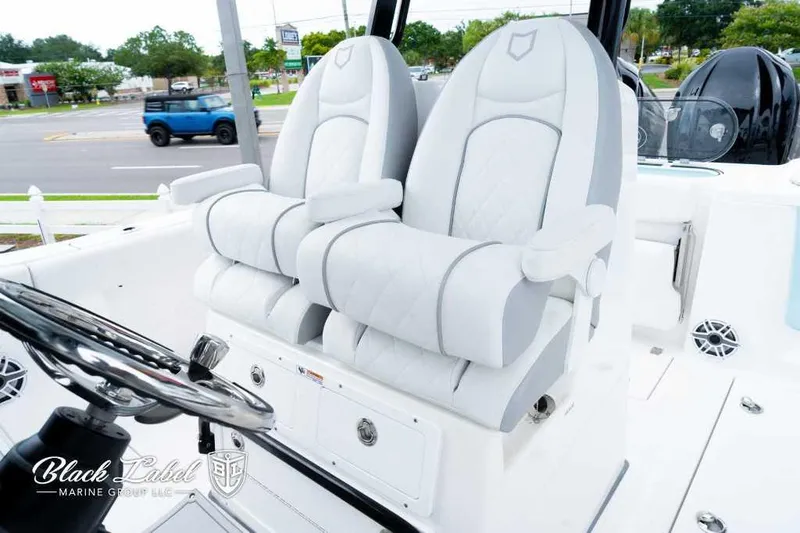 Slide: The Image of 2025 Sea Fox 288 Commander Center Console boat with luxurious seating and steering wheel. - 16
