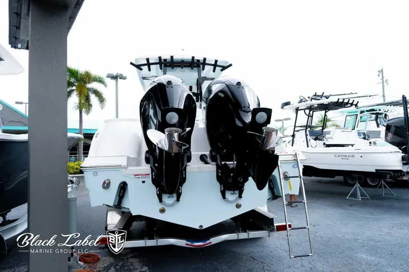 Slide: The Image of 2025 Sea Fox 288 Commander Center Console with dual outboard motors at marina. - 4