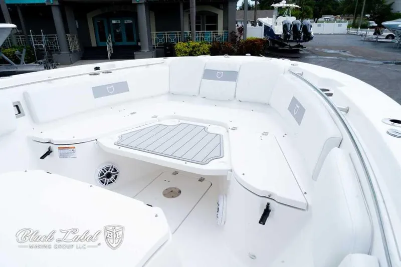 Slide: The Image of 2025 Sea Fox 288 Commander Center Console boat interior with white seating and deck. - 6