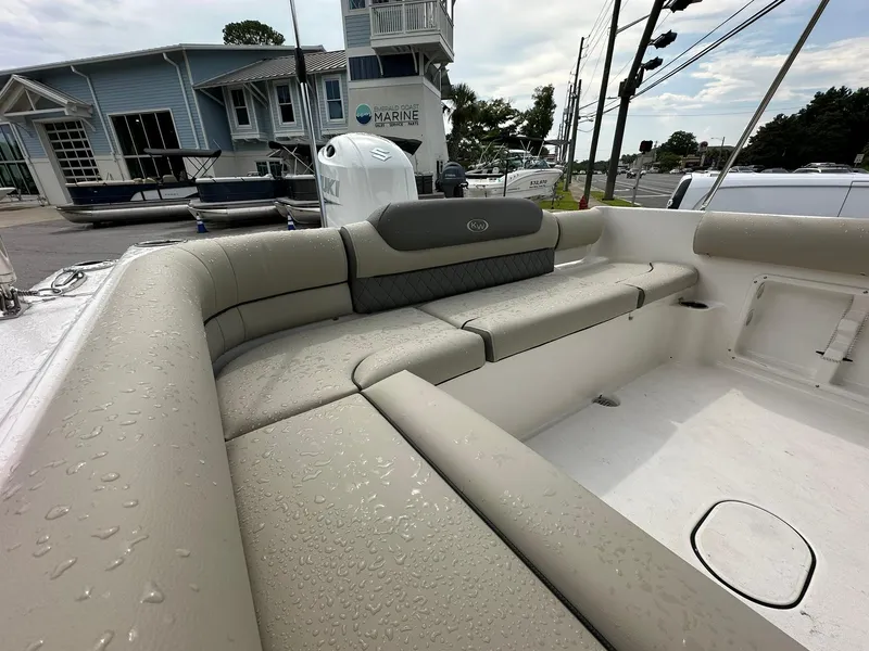 Slide: The Image of 2025 Key West 203 DFS boat with wet beige seating in a marina setting. - 10