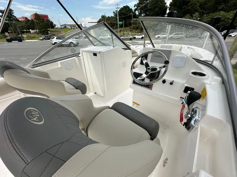 Slide: The Image of 2025 Key West 203 DFS boat interior with steering wheel and seating. - 6
