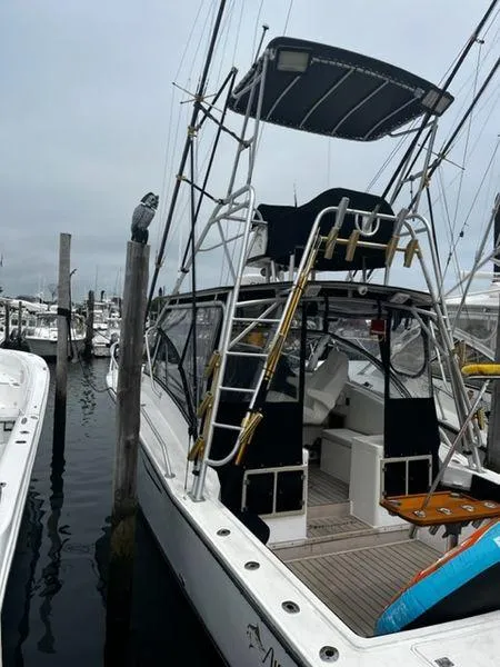 Slide: The Image of 1996 Albemarle 305 boat docked at marina with fishing equipment. - 1