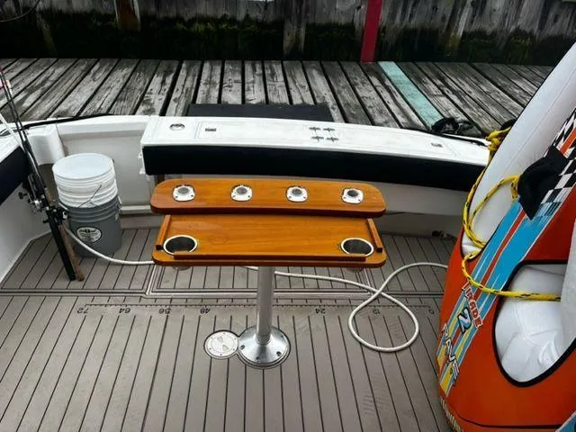 Slide: The Image of 1996 Albemarle 305 boat deck with wooden table and fishing rod holders. - 12