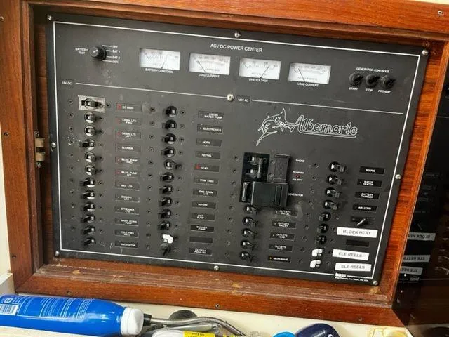 Slide: The Image of Albemarle 305 1996 boat electrical panel with switches and meters. - 18