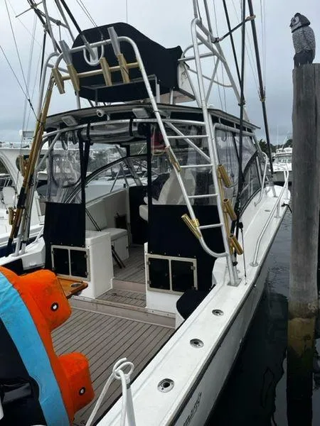 Slide: The Image of 1996 Albemarle 305 boat docked, featuring fishing equipment and a spacious deck. - 2