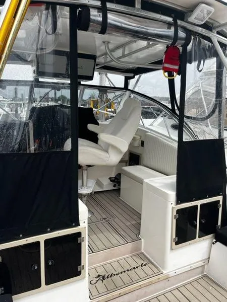 Slide: The Image of 1996 Albemarle 305 boat interior with seating and helm, featuring sleek design and modern amenities. - 3