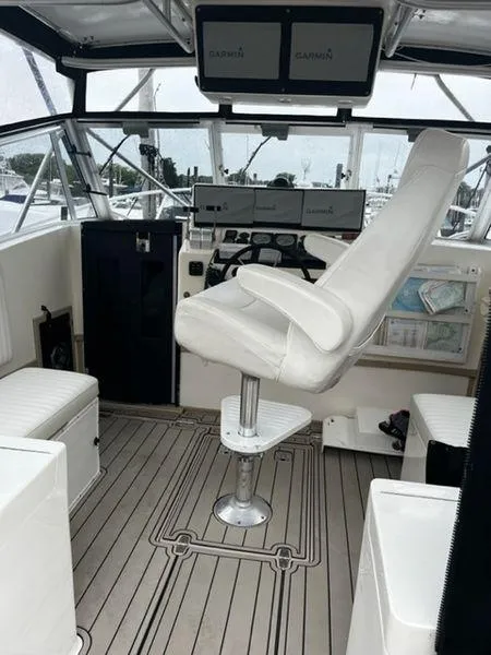 Slide: The Image of 1996 Albemarle 305 boat interior with captain's chair and navigation equipment. - 4