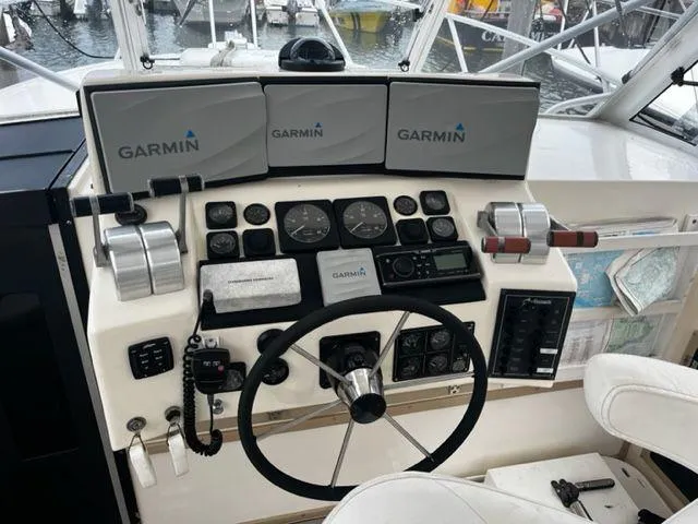 Slide: The Image of 1996 Albemarle 305 boat helm with Garmin navigation displays and controls. - 5