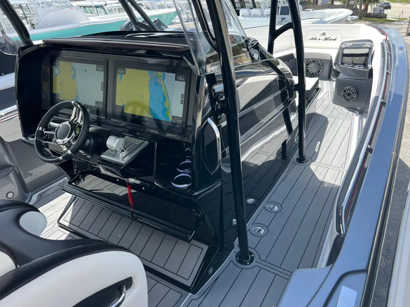 Slide: The Image of 2025 Nor-Tech 390 Sport Center Console with advanced navigation displays and sleek interior design. - 11