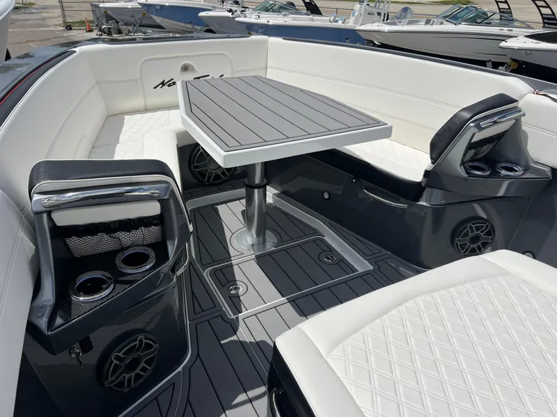 Slide: The Image of 2025 Nor-Tech 390 Sport Center Console interior with sleek seating and modern table design. - 14