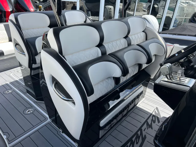 Slide: The Image of 2025 Nor-Tech 390 Sport Center Console seating, luxurious black and white design. - 18