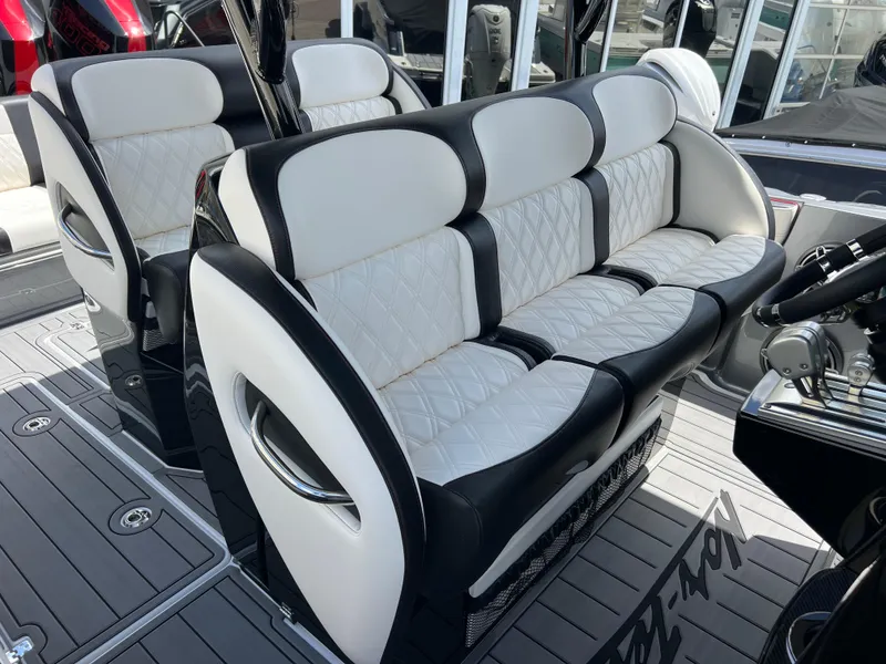 Slide: The Image of 2025 Nor-Tech 390 Sport Center Console, luxurious seating with black and white upholstery. - 19
