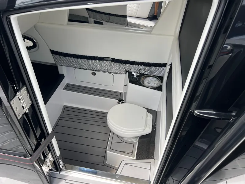 Slide: The Image of 2025 Nor-Tech 390 Sport Center Console interior with modern marine toilet. - 23