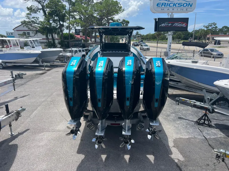 Slide: The Image of 2025 Nor-Tech 390 Sport Center Console with four powerful outboard engines. - 4