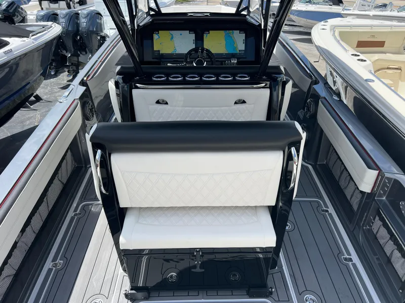 Slide: The Image of 2025 Nor-Tech 390 Sport Center Console with modern dashboard and seating. - 6