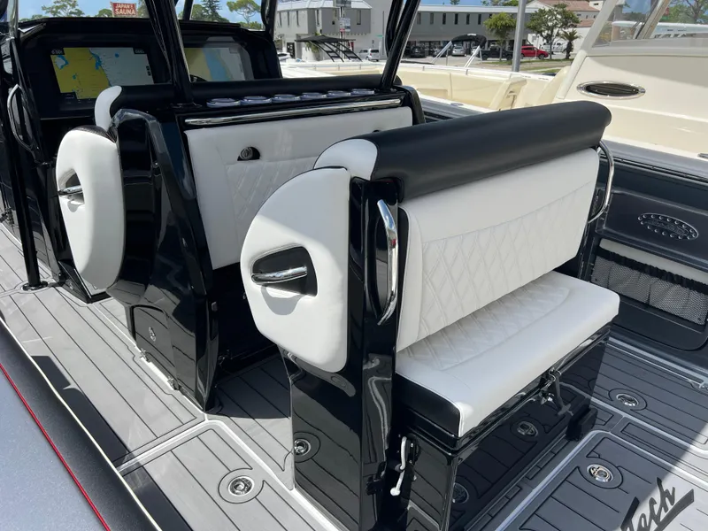 Slide: The Image of 2025 Nor-Tech 390 Sport Center Console interior with sleek black and white seating. - 7