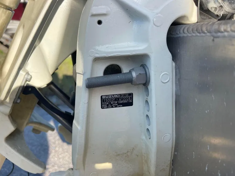 Slide: The Image of Close-up of a 2017 Manitou 25 Oasis boat component with visible bolt and label. - 11