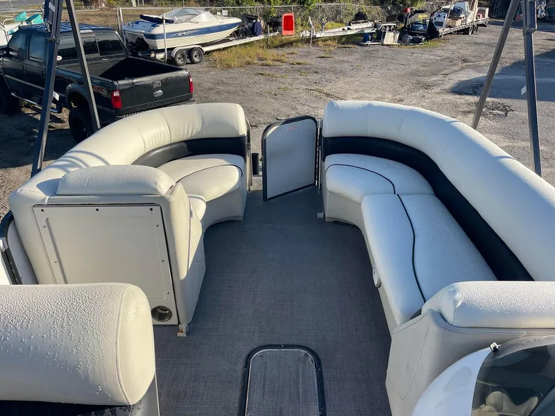 Slide: The Image of 2017 Manitou 25 Oasis pontoon boat with spacious seating and open deck layout. - 4