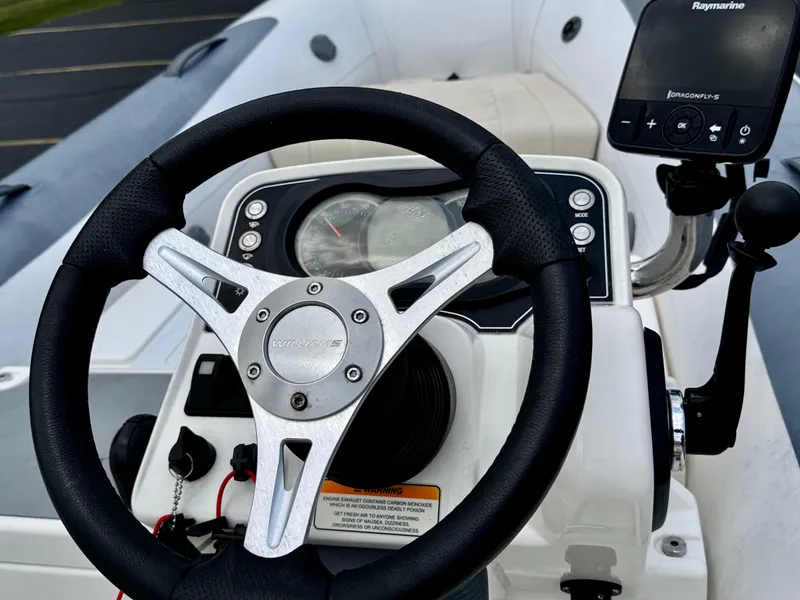 Slide: The Image of 2019 Williams Jet Tenders Sportjet 395 dashboard with steering wheel and navigation system. - 11