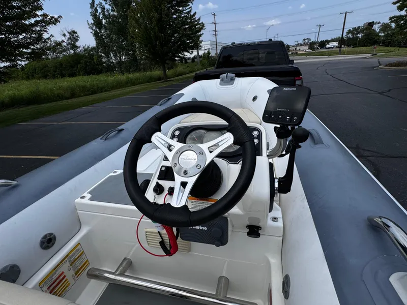 Slide: The Image of 2019 Williams Jet Tenders Sportjet 395, steering console view in parking lot. - 12