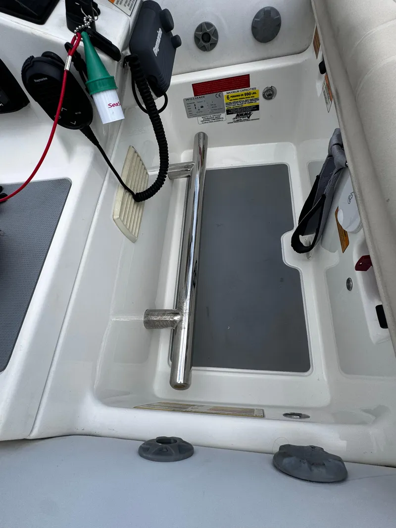 Slide: The Image of 2019 Williams Jet Tenders Sportjet 395 interior controls and seating area. - 22