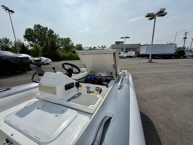Slide: The Image of 2019 Williams Jet Tenders Sportjet 395 in a parking lot, showcasing open storage compartment. - 24