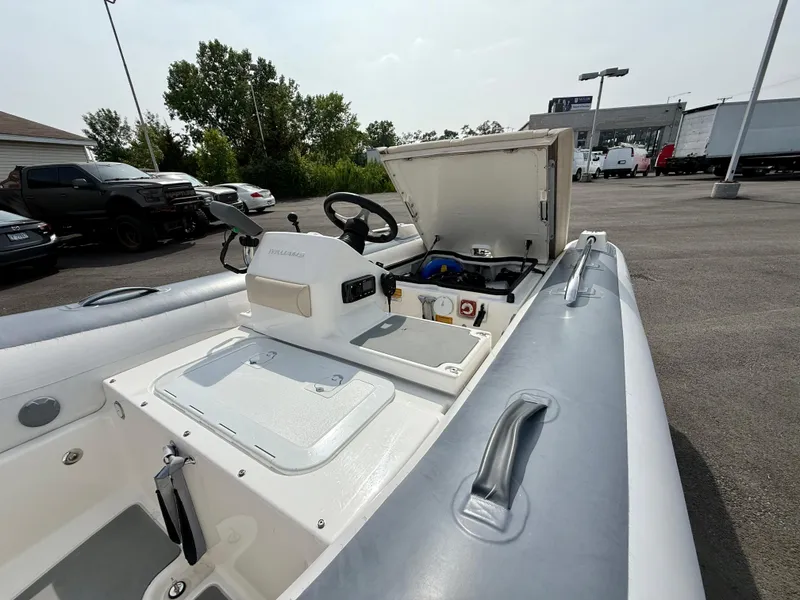 Slide: The Image of 2019 Williams Jet Tenders Sportjet 395, open storage compartment, parked outdoors. - 25