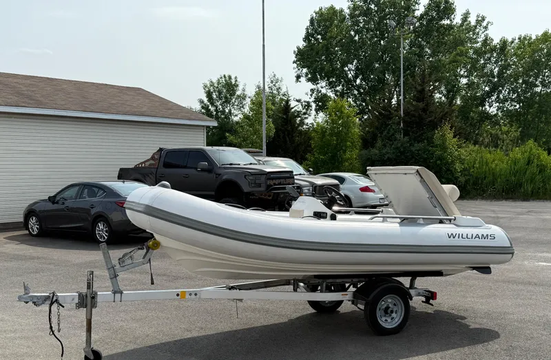 Slide: The Image of 2019 Williams Jet Tenders Sportjet 395 on trailer, parked in a lot with cars. - 39