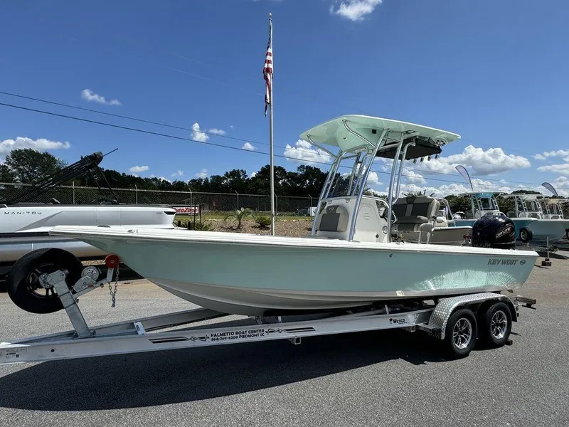 Slide: The Image of 2025 Key West 230 BR boat on trailer under clear sky. - 12