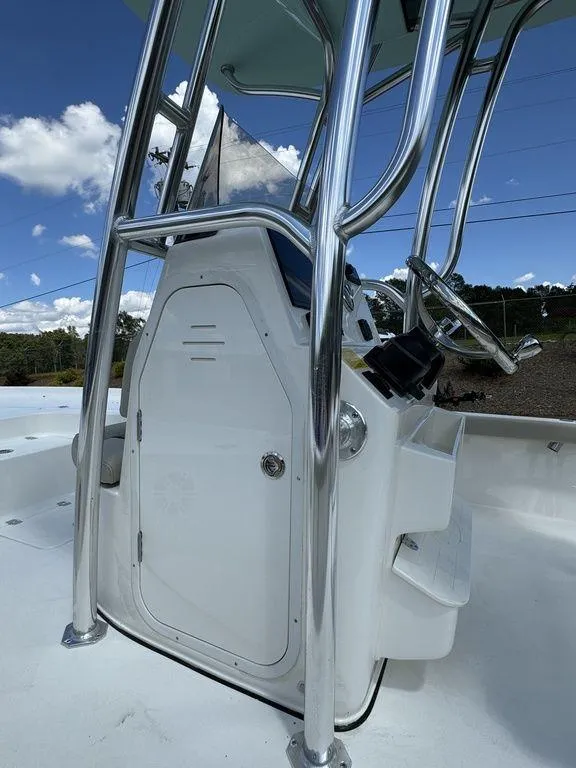 Slide: The Image of 2025 Key West 230 BR boat console with stainless steel frame under blue sky. - 15